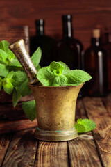 Fresh mint leaves in an old brass mortar.