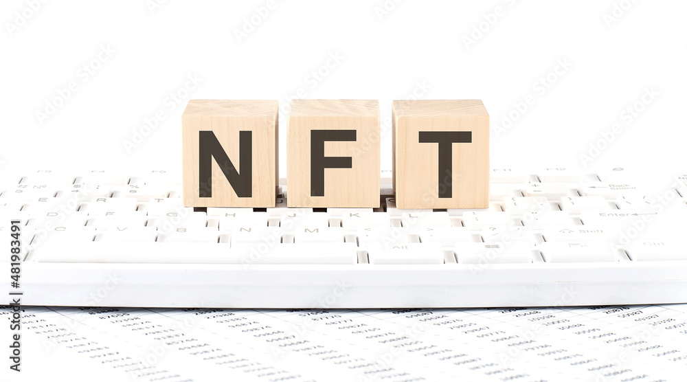 Poster nft -word wooden block on keyboard background witn chart