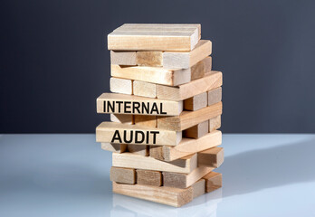 The text on the wooden blocks INTERNAL AUDIT
