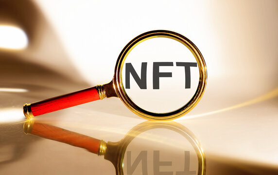NFT concept. Magnifier glass with text on white background in sunlight. - Powered by Adobe