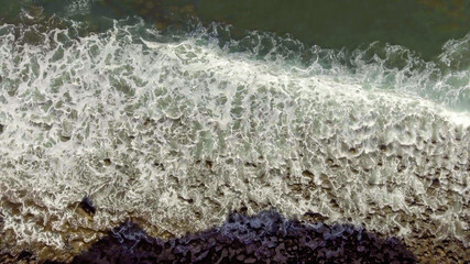 Overhead aerial view of beautiful Tenerife black beach, Spain.