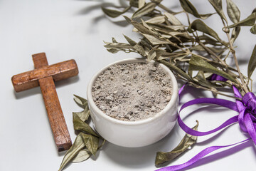 bowl with ashes and olive branch. ash wednesday concept