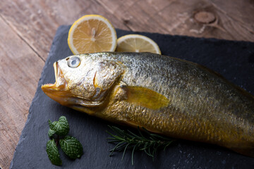 Yellow croaker fish on black 