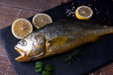 Yellow croaker fish on black 