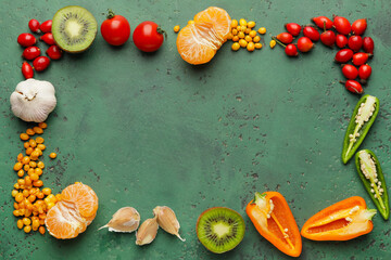 Frame made of different healthy products on green background
