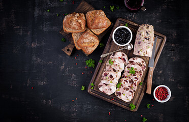 Delicious meat terrine with slice chicken, green peas and dried fruits. Meatloaf. Top view, above