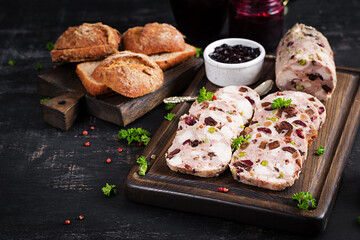Delicious meat terrine with slice chicken, green peas and dried fruits. Meatloaf.