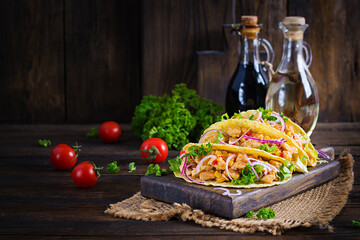 Mexican tacos with chicken meat, vegetables and red onion. Mexican taco.