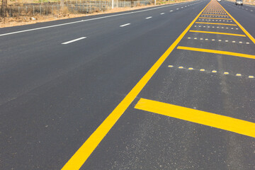 Asphalt road as abstract background, yellow line on the road texture