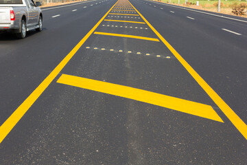 Asphalt road as abstract background, yellow line on the road texture