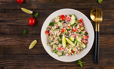 Tabbouleh salad. Traditional middle eastern or arab dish. Levantine vegetarian salad with parsley, cucumber, couscous, tomato. Top view, above