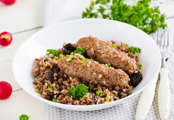 Healthy dinner. Lunch bowl with buckwheat porridge, baked meat cutlets and roasted eggplants.