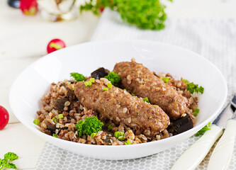 Healthy dinner. Lunch bowl with buckwheat porridge, baked meat cutlets and roasted eggplants.
