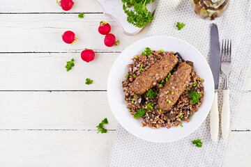 Healthy dinner. Lunch bowl with buckwheat porridge, baked meat cutlets and roasted eggplants. Top view, above