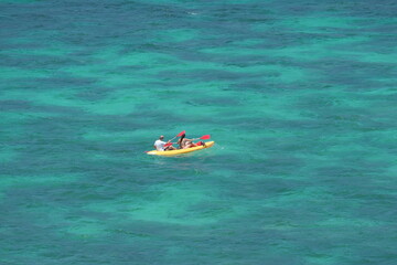 Tourists kayaking in the sea
