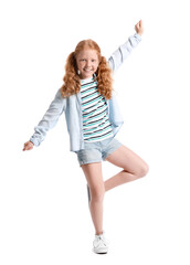 Little redhead girl with ponytails dancing on white background