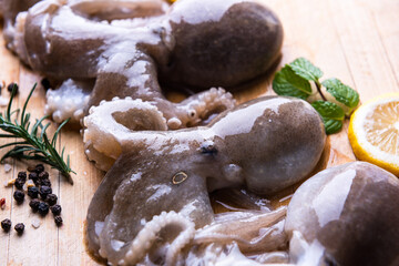 Baby octopus with lemon and rosemary. Selective focus