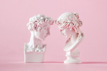 gypsum antique bust of man and woman on pink background, concept of love trust and valentine's day - obrazy, fototapety, plakaty