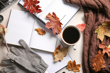 Naklejka na ściany i meble Blank books, warm gloves, cup of coffee and autumn decor on light background