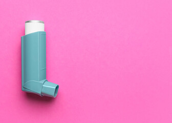 Asthma inhaler on color background