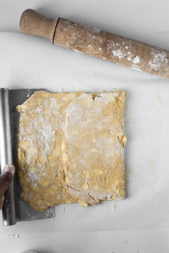 danish pastry dough being laminated, pastry dough with pieces of cold butter, process of laminating dough, letterfold pastry dough