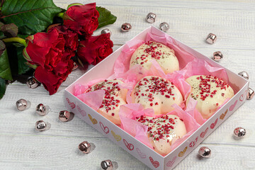 Handmade gingerbread in white chocolate on a light background. Festive packaging.