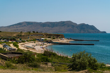 Fototapeta na wymiar The Republic of Crimea. July 11, 2021. Beaches in Kapsel Bay near the town of Sudak.