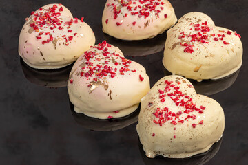 Handmade gingerbread in white chocolate on a light background. Festive packaging.