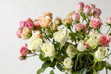 Bouquet of beautiful fresh roses on light background