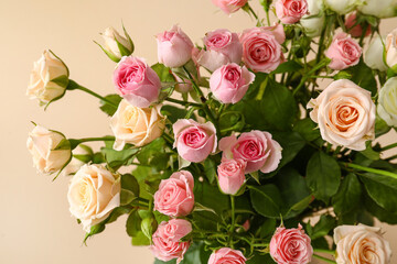 Fototapeta premium Elegant pink and cream rose bouquet with lush green leaves, romantic floral arrangement for celebrations and gifting
