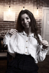 Portrait of a young beautiful long-haired girl. Vintage black and white photo.
