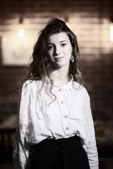 Portrait of a young beautiful long-haired girl. Vintage black and white photo.