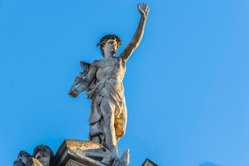 Lviv, Ukraine - January, 2022: statue of Mercury (Hermes) on the roof of an ancient house.