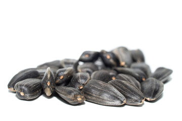 Close-up of delicious sunflower black seeds, isolated on white background