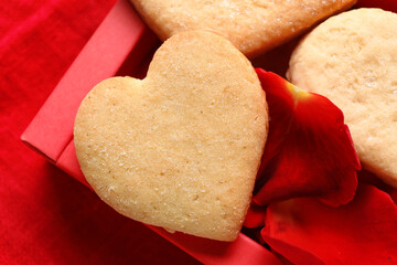Box with tasty heart shaped cookies on table, closeup. Valentines Day celebration