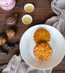 Popular mid autumn food items and lanterns display. Mooncake, Chinese Tea, Taro, Water Caltrop and Lanterns. The Chinese characters translate as double egg yolk lotus paste and red bean paste.