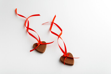 Two cookies hearts on Valentines Day with red ribbon on white background. Mothers day