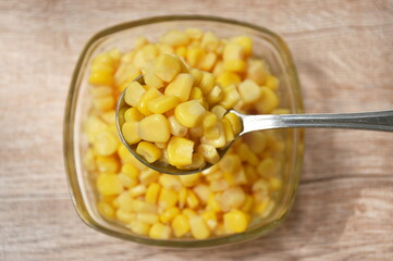 steamed sweet corn seed in salt water on spoon
