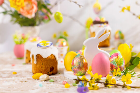 Easter still life with colorful Easter cakes, Easter eggs on rabbit dessert plate. Traditional Easter treat