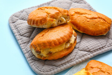 Tasty sochniki with cottage cheese on blue background