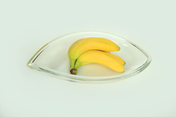 Obraz na płótnie Canvas Fresh bananas in a modern glass bowl