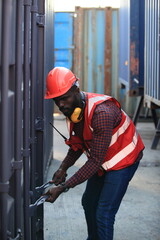 African American handsome black engineer he is working in container box yard area of  logistics...