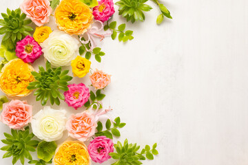 Composition of beautiful flowers, succulents and leaves on light background. Flowers frame.Top view, copy space.