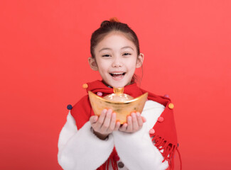  Happy girl holding a gold ingot and celebrating chinese new year