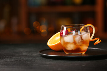 Glass of tasty Old Fashioned Cocktail on table in bar