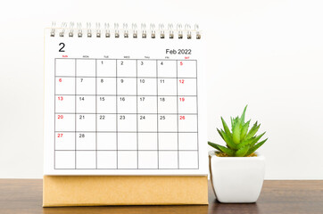 February 2022 desk calendar with plant pot.