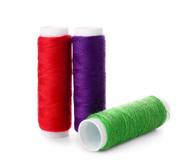 Different sewing thread spools on white background