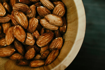 almonds in a wooden bowl, top view
