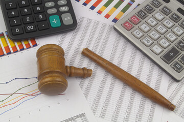 Broken judge gavel and calculators on financial documents. Wrong arbitration, audition and...