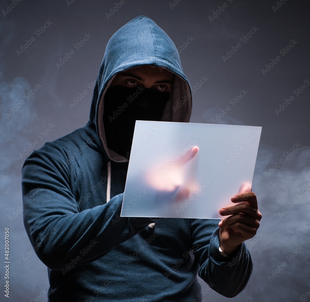 Aufkleber hacker working on tablet in dark